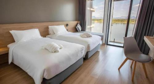 Ένα ή περισσότερα κρεβάτια σε δωμάτιο στο Chewa Khong Hotel Nakhon Phanom