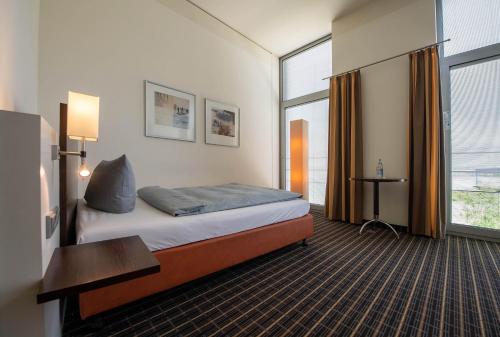 Ένα ή περισσότερα κρεβάτια σε δωμάτιο στο Livenwork Hotel & CoWorking GVZ Ingolstadt