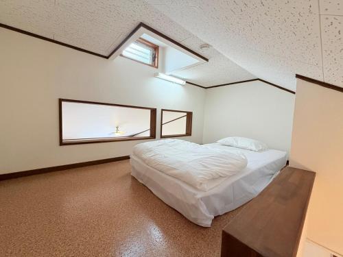 Ένα ή περισσότερα κρεβάτια σε δωμάτιο στο ハイツ清水204