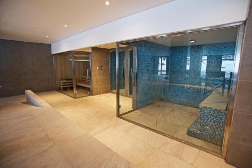 an empty room with glass doors and a room with a staircase at Grand Hotel Caviahue in Caviahue