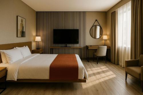 ein Hotelzimmer mit einem Bett und einem Flachbildfernseher in der Unterkunft Remsyatan Viuse in Abuja