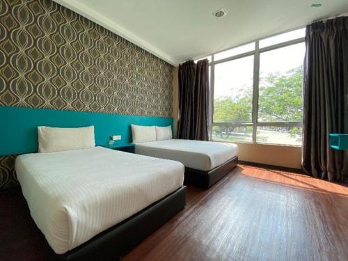 Ένα ή περισσότερα κρεβάτια σε δωμάτιο στο OYO 89752 7 DAYS EXPRESS HOTEL