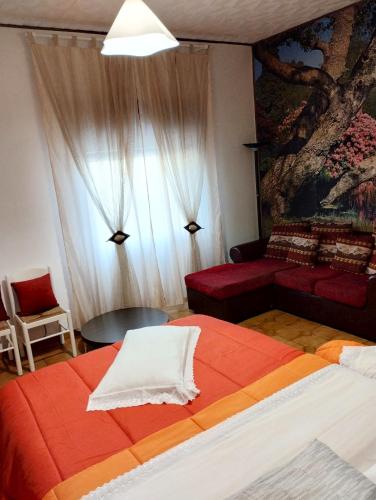 a bedroom with a large bed and a couch at Nonno Nanni casa vacanze in Portocannone