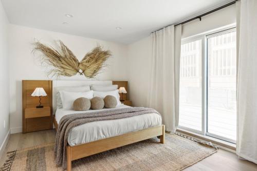 a bedroom with a bed and a large window at Tide House - Unit A - Modern Seaside 1BD w Parking in El Segundo