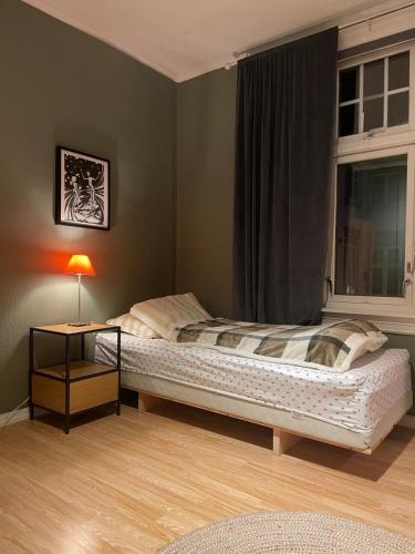 a bedroom with a bed and a window at Brekkehagen in Skien