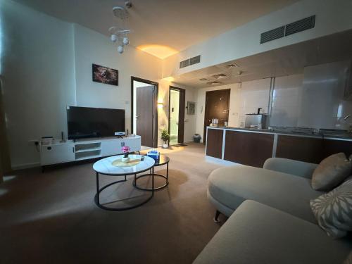 a living room with a couch and a table at Suite one bedroom apartment Down town abudhabi in Abu Dhabi