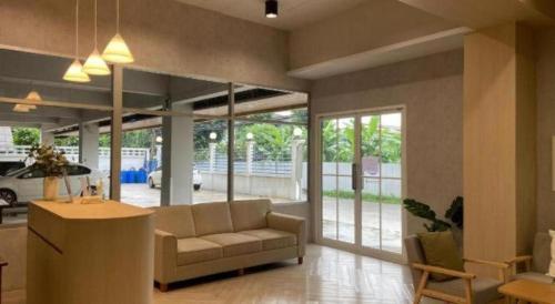 a living room with a couch and a table at Next Bird Suite in Bangkok