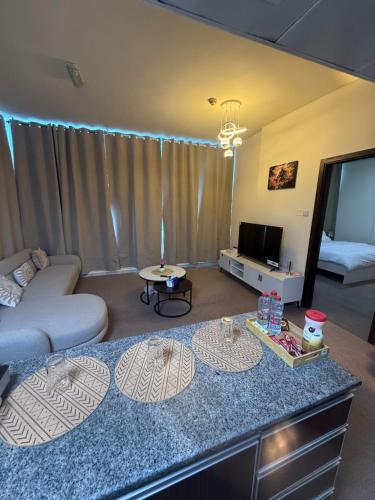 a living room with a couch and a table at Suite one bedroom apartment Down town abudhabi in Abu Dhabi