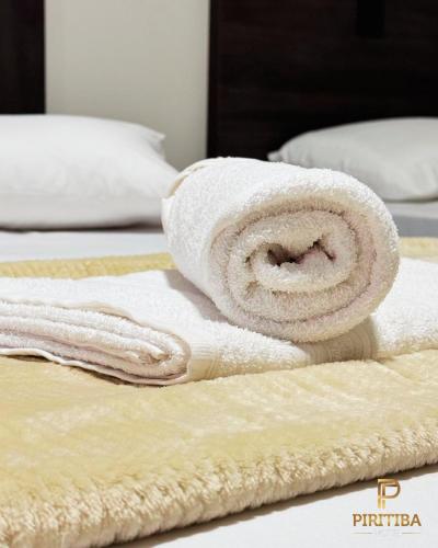 a pile of towels sitting on top of a bed at Piritiba Hotel in Mato Verde
