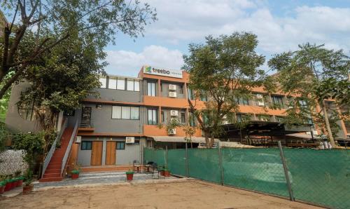 a building with a fence in front of it at Treebo Executive Suites in Gandhinagar