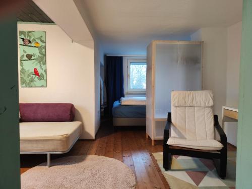 a living room with a couch and a chair at FeWo Aisch in Bad Windsheim