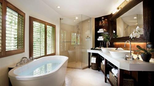 a bathroom with two sinks and a bath tub at Rayavadee - Pool Pavilion in Railay Beach
