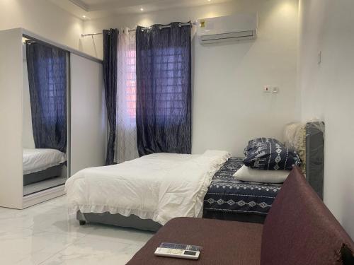 a small bedroom with a bed and a mirror at Luxury Live Inn Suite in Owuraman