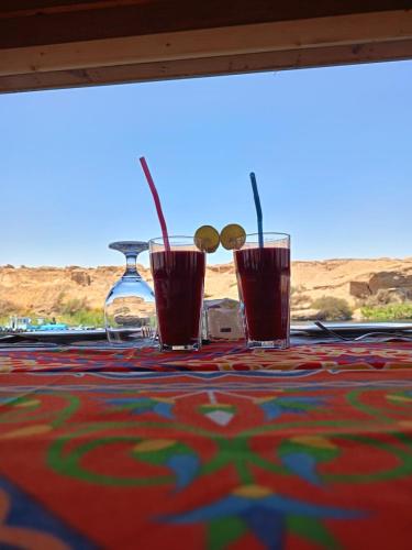 two glasses with straws sitting on a table at Nile SE Felucca nile cruise private tour in Naj‘ al ‘Amrāb