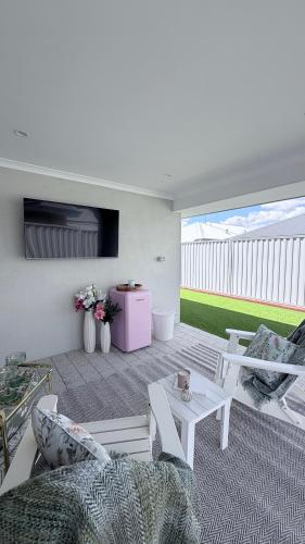 a living room with a couch and a table at Aweehomethevalley in Henley Brook