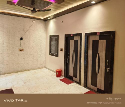 a room with two doors and a red trash can at Shree Ram Palace in Ayodhya
