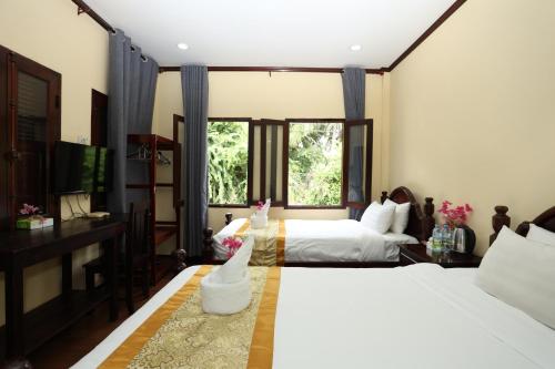 Ένα ή περισσότερα κρεβάτια σε δωμάτιο στο Villa Sengchalern
