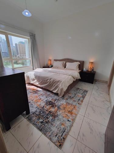 a bedroom with a bed and a large window at Delightful Private Rooms with Garden View in Sharjah