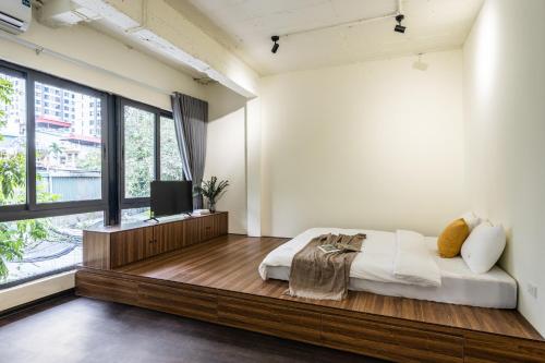 a bedroom with a large bed and a large window at Sweet Home in Hanoi