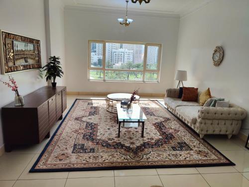 a living room with a couch and a coffee table at Delightful Private Rooms with Garden View in Sharjah