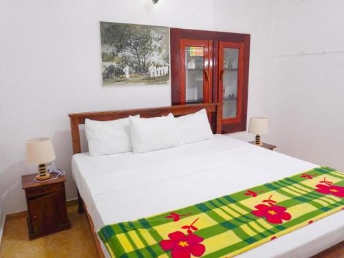 En eller flere senge i et værelse på Vintage Grove Weligama