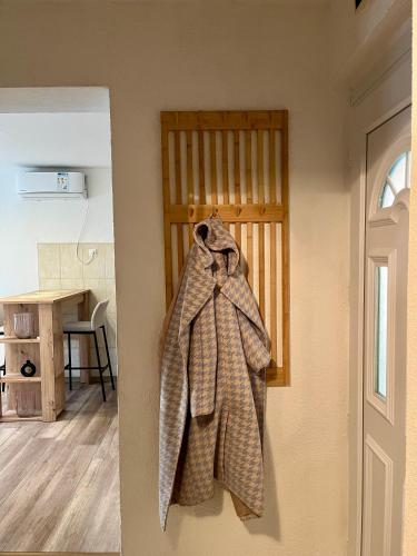 a coat is hanging on a wall in a room at Apartman Nota in Vinkovci