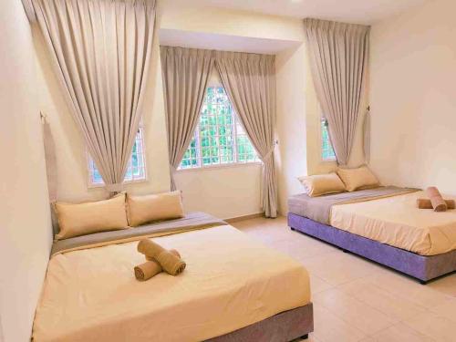 zwei Betten in einem Zimmer mit zwei Fenstern in der Unterkunft Area Indahpura or Taman Bersatu Kulai 3-4BR near AEON Airport JPO in Kulai