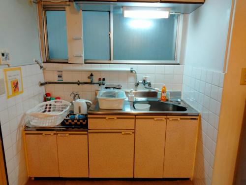 a kitchen with a sink and a counter top at 波除ハイツ in Osaka