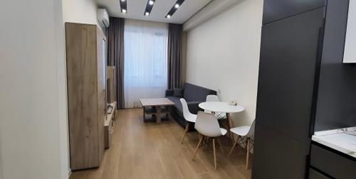 a living room with a table and chairs in a room at CozyNest Apartment In Yerevan, Center in Yerevan