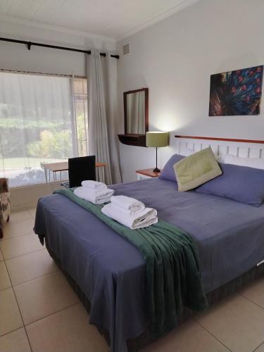 a bedroom with two beds with towels on them at Fair Haven Guest Suite Self-catering in Marina Beach