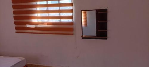a bedroom with a window and a mirror at Alnwatif Gate guest house Dana nature reserve in Dana