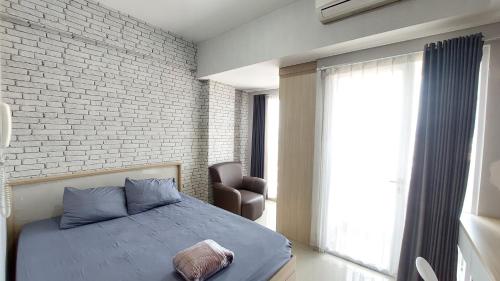 Ένα ή περισσότερα κρεβάτια σε δωμάτιο στο Apartemen Taman Melati Yogyakarta Sinduadi by ArFe Room