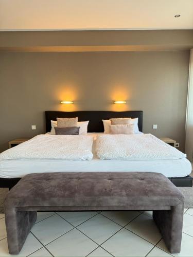 a bedroom with a large bed with two pillows at Ferienwohnung Lodge 43 in Trier