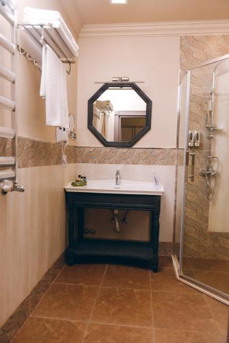 a bathroom with a sink and a mirror at Vogue Nabran Hotel in Xaçmaz