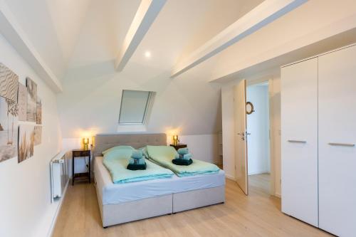 Giường trong phòng chung tại Ferienhaus DeichKate