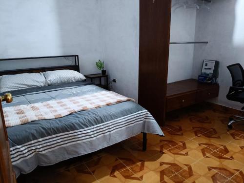 a bedroom with a bed and a desk and a chair at Cerca de pirámides, bancos, centros, UDLA, paradas in Cholula