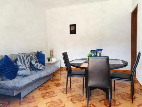 a living room with a couch and a table and chairs at Cerca de pirámides, bancos, centros, UDLA, paradas in Cholula