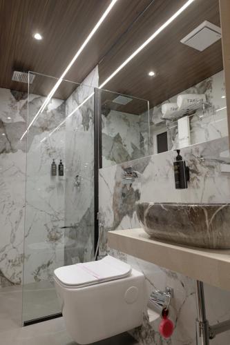 a bathroom with a sink and a toilet and a shower at Planet Boutique Hotel in Mumbai