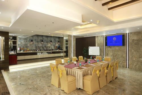 ムンバイにあるPlanet Boutique Hotelの会議室(長いテーブル、黄色い椅子付)