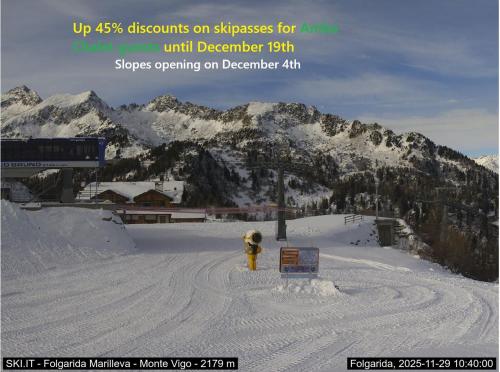 a yellow fire hydrant in the middle of a snow covered mountain at Amba Chalet Famiglia Cima - Quadrilocale 6 posti letto in Mezzana