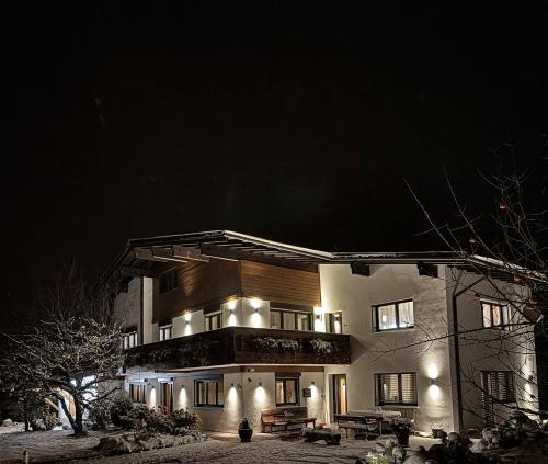 a large house at night with lights at Haus Galgenul by A-Appartments in Galgenul