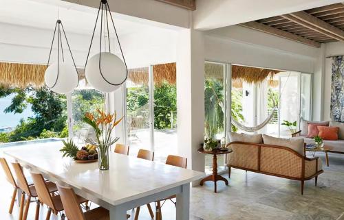 a dining room with a white table and chairs at Spectacular view overlooking the famous Boracay white beach ! in Boracay