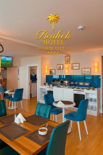 a kitchen and dining room with a table and chairs at Beach Hotel Orbi City in Batumi