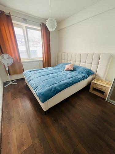 a bedroom with a large bed with a blue blanket at Zilina Sweet Escape in Žilina