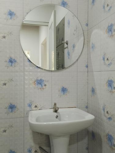 a bathroom with a sink and a mirror on the wall at A Nature House in Ko Lanta Yai