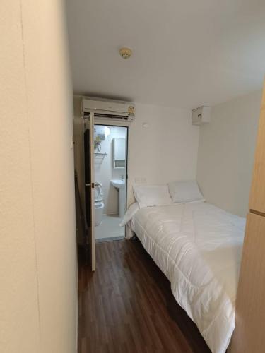 a bedroom with a white bed and a bathroom at Affordable Private Studio Al Reem Island in Abu Dhabi