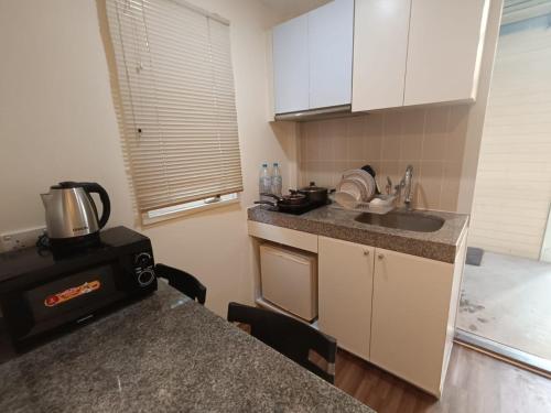 a small kitchen with a sink and a counter top at Affordable Private Studio Al Reem Island in Abu Dhabi