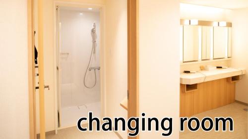 a bathroom with a shower and a sink and a mirror at HOTEL LADIES PLAZA YOKOTE -female only- in Yokote