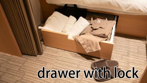 a box of towels sitting on the floor next to a bed at HOTEL LADIES PLAZA YOKOTE -female only- in Yokote