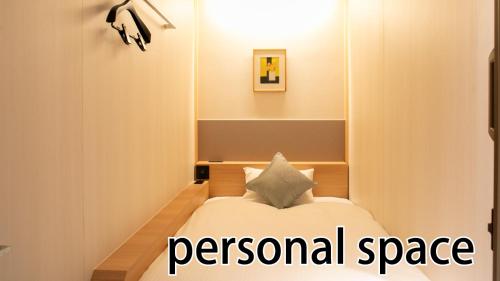 a room with a bed and a sign that reads personal space at HOTEL LADIES PLAZA YOKOTE -female only- in Yokote